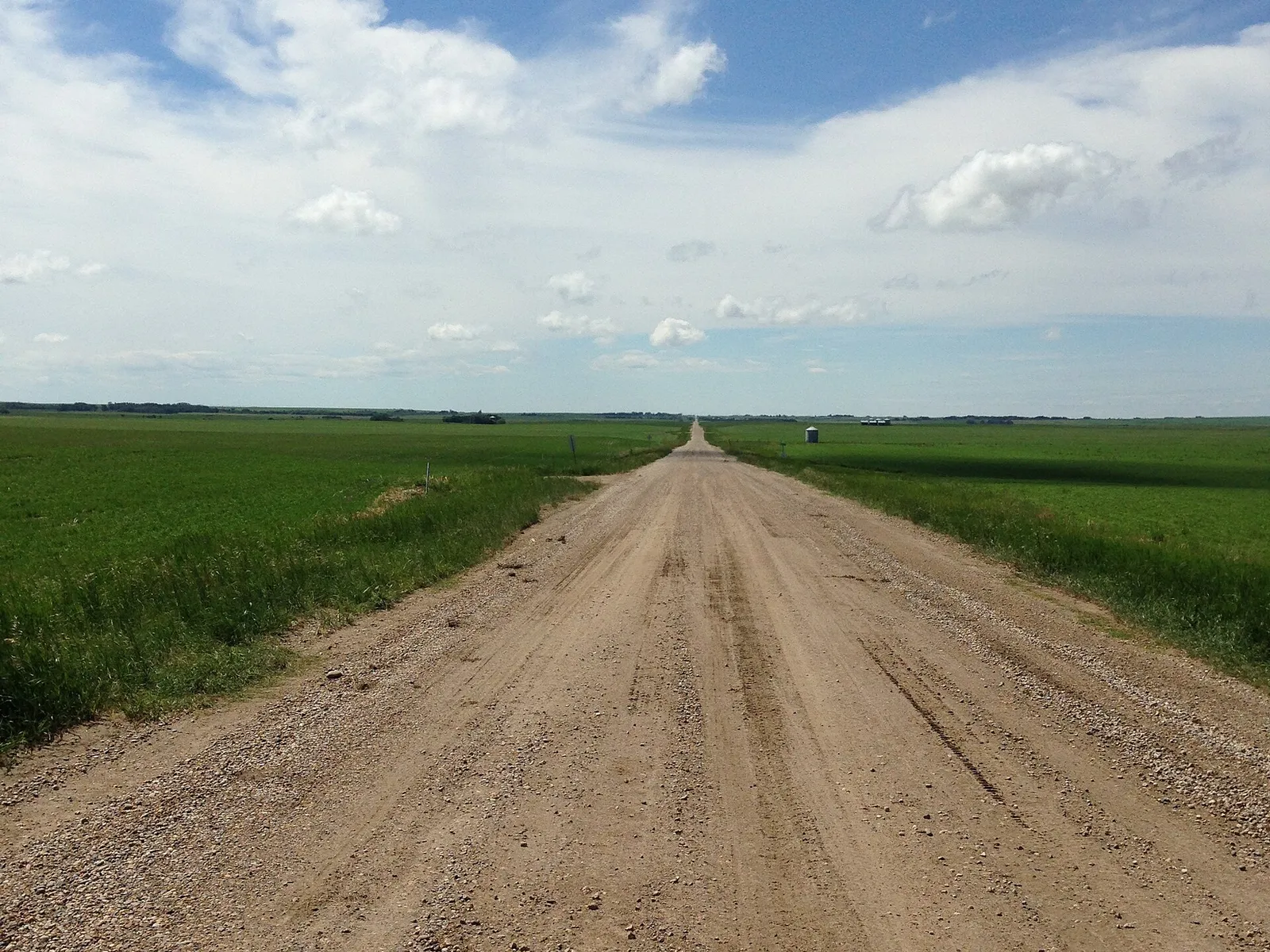 Gravel road between farm fields at Rockyford, Alberta