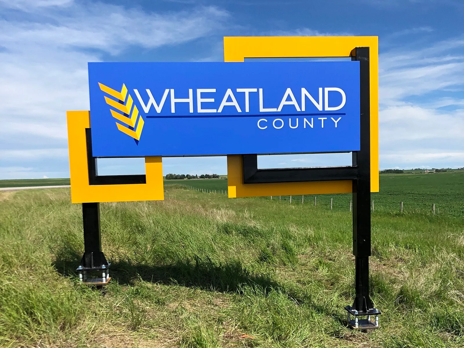 Wheatland County welcome sign beside a field