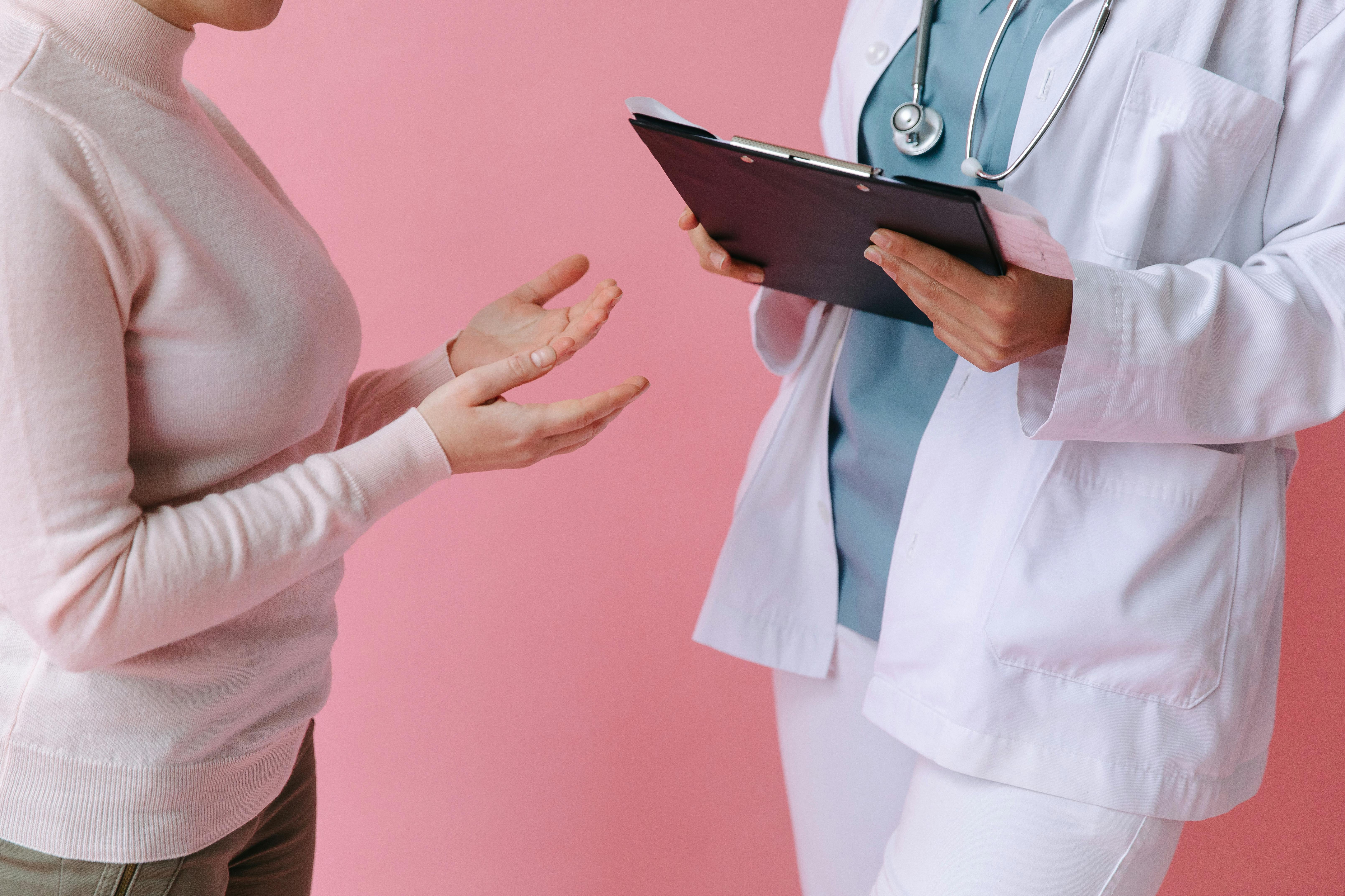 Doctor taking notes from patient